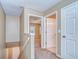 Upstairs hallway with carpet, doors to bedrooms and bathroom, and stairs at 2131 Golden Oak Ln, Valrico, FL 33594
