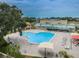 Aerial view of community pool with surrounding lounge chairs at 2228 Swedish Dr # 2, Clearwater, FL 33763