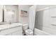 Well-lit bathroom with tub-shower combination, white vanity and cabinets, and a large mirror at 2762 Pearly Banks Dr, Bradenton, FL 34208