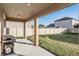 Covered patio with backyard access and grill at 30868 Kelmin Ter, Wesley Chapel, FL 33543
