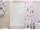 Bathroom with a shower/tub combo and Paris-themed curtain at 30868 Kelmin Ter, Wesley Chapel, FL 33543