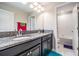 Double vanity bathroom with granite countertop at 30868 Kelmin Ter, Wesley Chapel, FL 33543