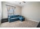 Guest bedroom with a blue sectional sofa and large window at 30868 Kelmin Ter, Wesley Chapel, FL 33543