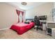 Bedroom with a bed, desk, and gaming chair at 30868 Kelmin Ter, Wesley Chapel, FL 33543