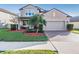 Two-story house with landscaped yard and two-car garage at 30868 Kelmin Ter, Wesley Chapel, FL 33543