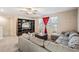 Gathering room with sectional sofa and built-in entertainment center at 30868 Kelmin Ter, Wesley Chapel, FL 33543