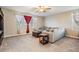 Spacious Gathering room with sectional sofa, carpet, and large windows at 30868 Kelmin Ter, Wesley Chapel, FL 33543