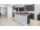 Spacious kitchen with dark cabinets, granite counters, and stainless steel appliances at 30868 Kelmin Ter, Wesley Chapel, FL 33543