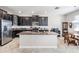Modern kitchen with island, granite counters, and stainless steel appliances at 30868 Kelmin Ter, Wesley Chapel, FL 33543
