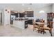 Kitchen with an island, breakfast nook, and dark wood cabinets at 30868 Kelmin Ter, Wesley Chapel, FL 33543