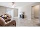 Bright living room features tile floors, a flat screen TV and comfortable seating at 30868 Kelmin Ter, Wesley Chapel, FL 33543