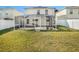 House with a screened patio and grassy backyard at 32328 Fish Hook Loop, Wesley Chapel, FL 33545