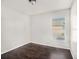 Simple bedroom with dark wood floors and a window at 32328 Fish Hook Loop, Wesley Chapel, FL 33545