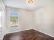 Small bedroom with dark wood floors and a window at 32328 Fish Hook Loop, Wesley Chapel, FL 33545