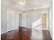 Spacious bedroom with dark wood floors and access to bathroom at 32328 Fish Hook Loop, Wesley Chapel, FL 33545