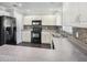 Modern kitchen with white cabinets, black appliances, and granite countertops at 32328 Fish Hook Loop, Wesley Chapel, FL 33545
