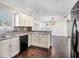 Modern kitchen with white cabinets, black appliances, and granite countertops at 32328 Fish Hook Loop, Wesley Chapel, FL 33545