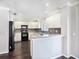 Modern kitchen with white cabinets, black appliances, and granite countertops at 32328 Fish Hook Loop, Wesley Chapel, FL 33545