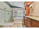 Updated bathroom with walk-in shower and granite vanity at 3314 W Barcelona St, Tampa, FL 33629