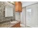 Updated bathroom with granite countertop and mosaic tile at 3314 W Barcelona St, Tampa, FL 33629