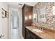 Elegant bathroom with mosaic tile, granite vanity, and access to a private courtyard at 3314 W Barcelona St, Tampa, FL 33629