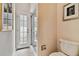 Bathroom with shower, toilet and door to private exterior access at 3314 W Barcelona St, Tampa, FL 33629