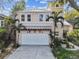 Two-story house with a white garage door and landscaping at 3314 W Barcelona St, Tampa, FL 33629