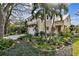 Two-story house with a lush, landscaped front yard and a metal roof at 3314 W Barcelona St, Tampa, FL 33629