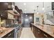 Spacious kitchen with granite countertops, stainless steel appliances, and dark wood cabinets at 3314 W Barcelona St, Tampa, FL 33629