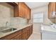 Laundry room with granite countertops and ample cabinetry at 3314 W Barcelona St, Tampa, FL 33629