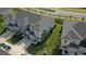 Aerial view of two-story townhouses with gray roofs and landscaping at 34196 Polacca Ln, Wesley Chapel, FL 33543