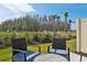 Enjoy the view from this backyard patio with seating area at 34196 Polacca Ln, Wesley Chapel, FL 33543