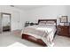 Bedroom with wooden bed frame and neutral bedding at 34196 Polacca Ln, Wesley Chapel, FL 33543