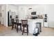 Modern kitchen with white cabinets, island, and stainless steel appliances at 34196 Polacca Ln, Wesley Chapel, FL 33543