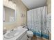 Bathroom with shower/tub combo, vanity, and seashell decor at 35921 Hermoso Ln, Zephyrhills, FL 33541