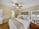 Main bedroom with king-size bed and ceiling fan at 35921 Hermoso Ln, Zephyrhills, FL 33541
