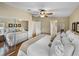 King-size bed, mirrored closet, and wood floors in this bright bedroom at 35921 Hermoso Ln, Zephyrhills, FL 33541