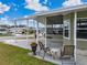 Home exterior with covered patio and seating area at 35921 Hermoso Ln, Zephyrhills, FL 33541
