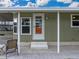 Front entrance to a manufactured home with steps and a covered porch at 35921 Hermoso Ln, Zephyrhills, FL 33541