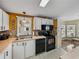 Kitchen features white cabinets, black appliances, and a breakfast nook at 35921 Hermoso Ln, Zephyrhills, FL 33541