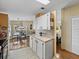 Open kitchen with white cabinets and a view into the dining area at 35921 Hermoso Ln, Zephyrhills, FL 33541