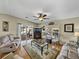 Living room featuring hardwood floors, fireplace, and comfortable seating at 35921 Hermoso Ln, Zephyrhills, FL 33541