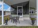 Cozy patio with small table and chairs, planters at 35921 Hermoso Ln, Zephyrhills, FL 33541