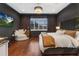 Luxurious main bedroom with a king-size bed, dark walls, and hardwood floors at 3608 W Horatio St, Tampa, FL 33609