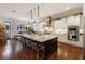 Gourmet kitchen boasts expansive island, stainless steel appliances, and white cabinetry at 3608 W Horatio St, Tampa, FL 33609