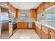 Modern kitchen featuring wood cabinets and stainless steel appliances at 425 150Th Ave # 2401, Madeira Beach, FL 33708