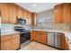 Modern kitchen with wood cabinets and stainless steel appliances at 425 150Th Ave # 2401, Madeira Beach, FL 33708