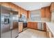 Kitchen with wood cabinets and stainless steel appliances at 425 150Th Ave # 2401, Madeira Beach, FL 33708
