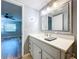 Bathroom boasts a vanity with quartz countertop and large mirror at 4507 S Oak Dr # P71, Tampa, FL 33611