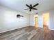 Bright bedroom with ceiling fan, wood-look floors, and access to bathroom and closet at 4507 S Oak Dr # P71, Tampa, FL 33611